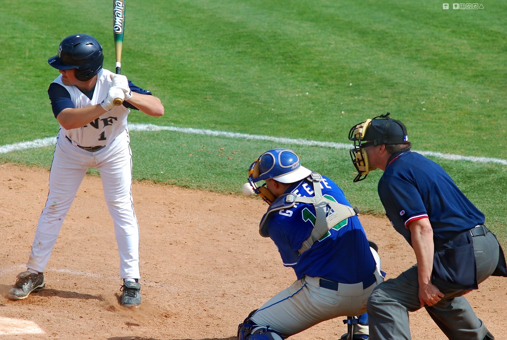 Runner sliding into base during a league game
