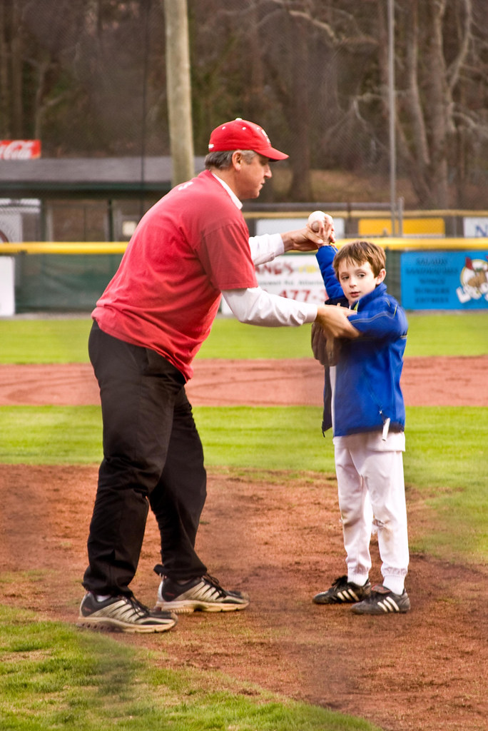 Coach giving a one-on-one lesson to a young player